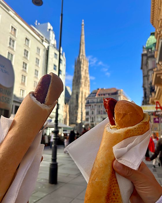 Two Viennese hot dogs with the Stephansdom in the background