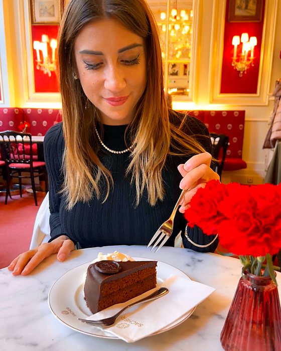 A slice of Sachertorte with cream at Café Sacher