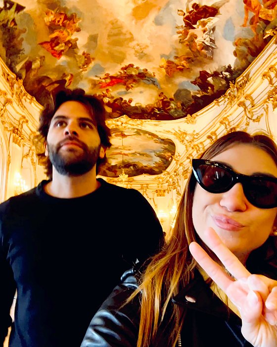 A couple's selfie in a baroque hall with a frescoed ceiling